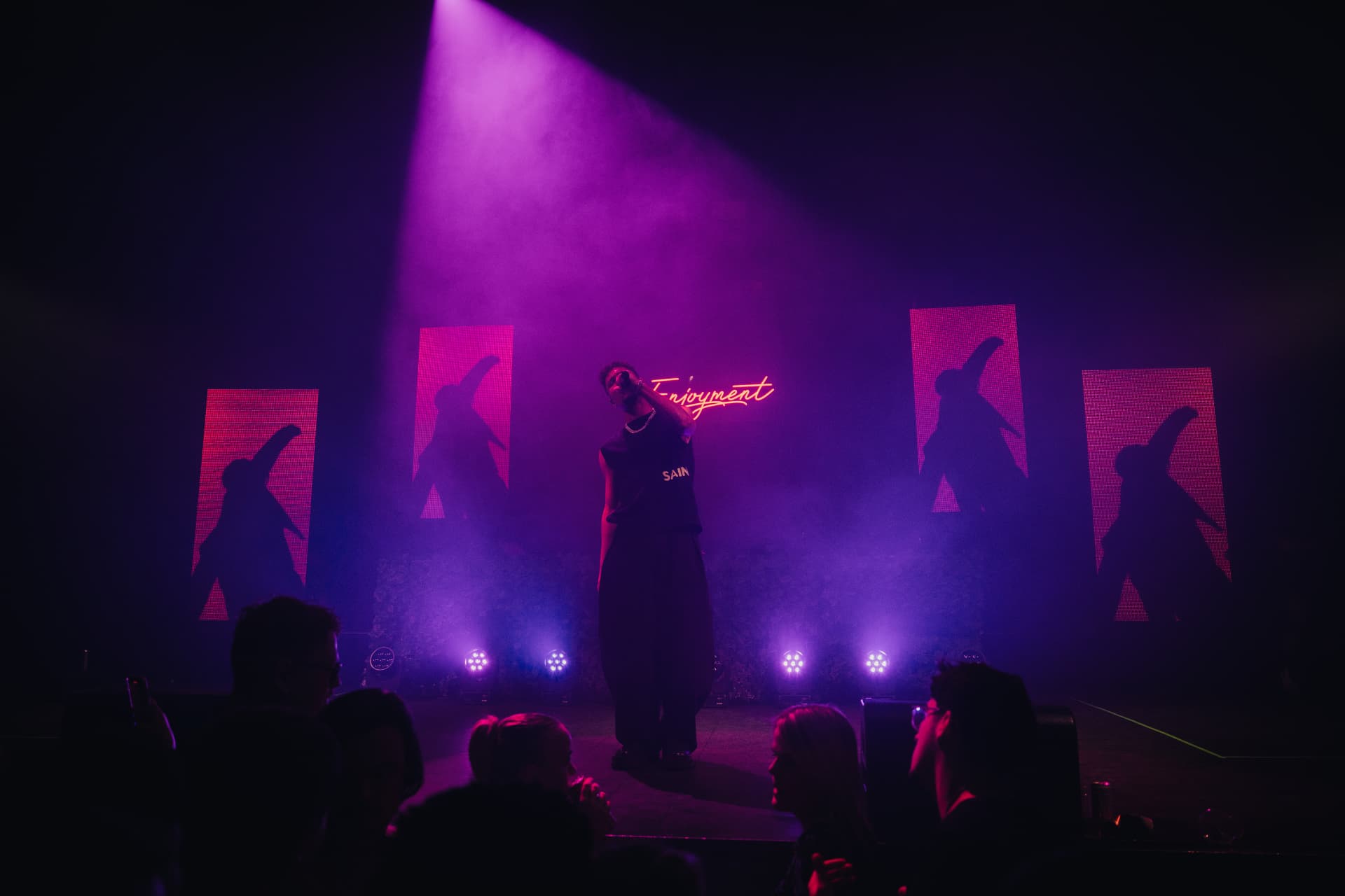 ELIKIA performing under purple stage lights